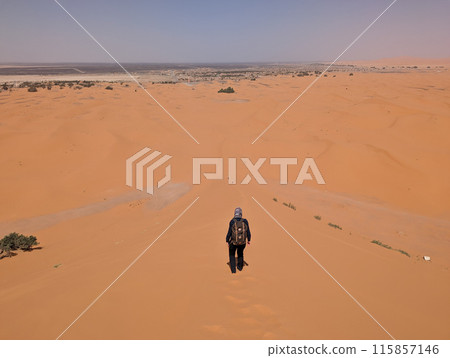 Hiking up the Great Dune of Merzouga in the Erg Chebbi desert, Moroccan Sahara 115857146