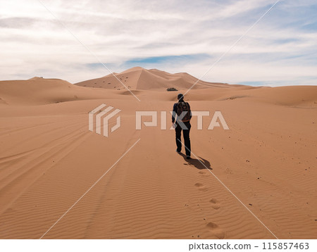 Hiking up the Great Dune of Merzouga in the Erg Chebbi desert, Morocco Hiking up the Great Dune of Merzouga in the Erg Chebbi desert, Morocco 115857463
