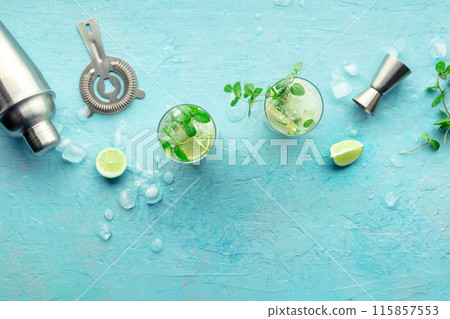 Mojito cocktail. Summer cold drink with lime, fresh mint, and ice. Cool beverage Mojito cocktail. Summer cold drink with lime, fresh mint, and ice. Cool beverage 115857553