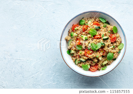 Quinoa tabbouleh salad in a bowl, a healthy dinner with tomatoes and mint Quinoa tabbouleh salad in a bowl, a healthy dinner with tomatoes and mint 115857555