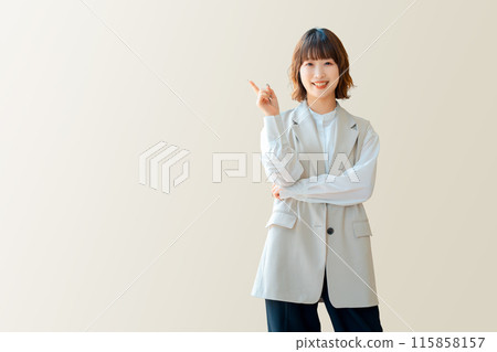 Smiling businesswoman pointing with her index finger 115858157