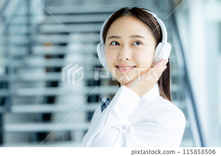 School girls listening to music with headphones 115858506