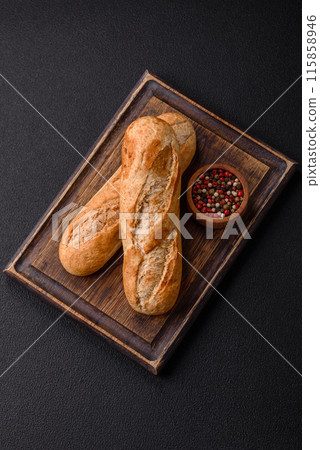 Crispy mini baguette with seeds and grains, salt and spices 115858946