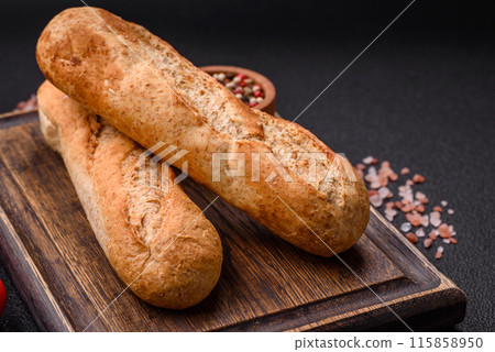Crispy mini baguette with seeds and grains, salt and spices 115858950