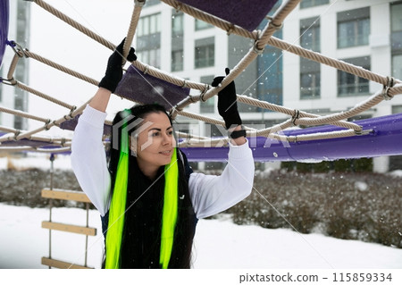 Woman Holding Onto Rope in Snow 115859334