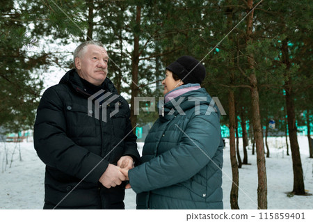 European mature family having fun walking through the winter forest 115859401