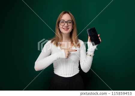 Woman in White Shirt Holding Cell Phone Woman in White Shirt Holding Cell Phone 115859453