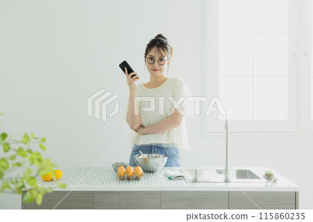 Woman in the kitchen 115860235