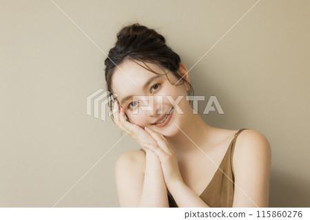 Young woman beauty image beige background 115860276