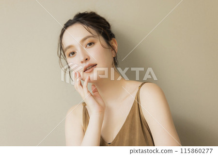 Young woman beauty image beige background 115860277