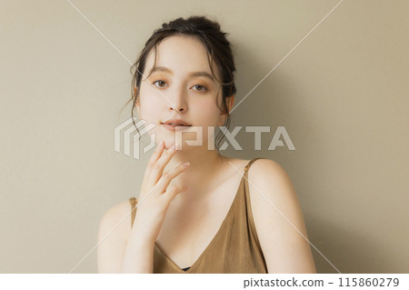 Young woman beauty image beige background 115860279