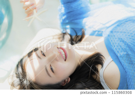 A woman in blue clothes lying on her back A woman in blue clothes lying on her back 115860308