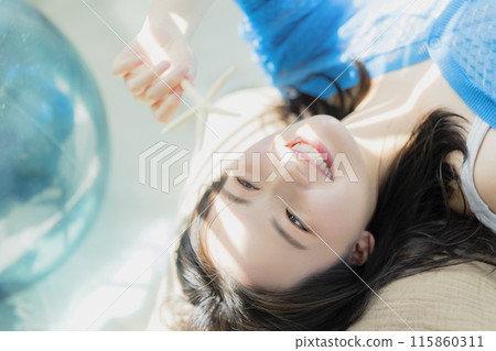 A woman in blue clothes lying on her back A woman in blue clothes lying on her back 115860311