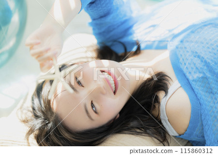 A woman in blue clothes lying on her back A woman in blue clothes lying on her back 115860312