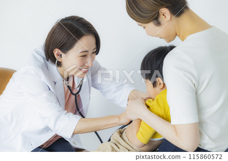 A female doctor examining a baby A female doctor examining a baby 115860572