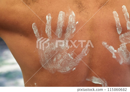 Bare man back hand marked sunscreen Bare man back hand marked sunscreen 115860682