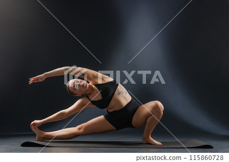 girl doing yoga and stretching, yoga and stretching poses on a dark background, yoga practice girl doing yoga and stretching, yoga and stretching poses on a dark background, yoga practice 115860728