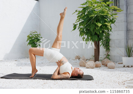 yoga stretching outdoors. side view of overweight woman practicing yoga on white background, body care concept 115860735