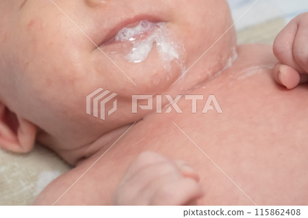 Image of a baby spitting up milk 115862408
