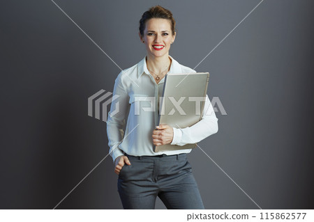 happy stylish woman worker isolated on grey background 115862577