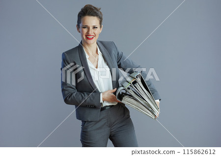smiling elegant 40 years old business woman isolated on grey smiling elegant 40 years old business woman isolated on grey 115862612