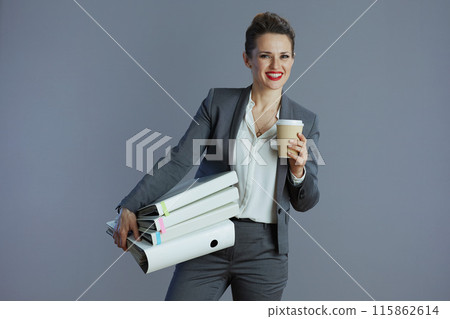 smiling elegant business woman isolated on gray smiling elegant business woman isolated on gray 115862614