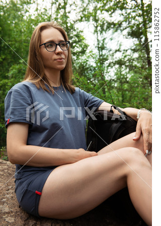 woman walking early in summer forest area woman walking early in summer forest area 115862752
