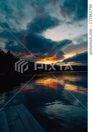 A calm evening sunset at the summer lake A calm evening sunset at the summer lake 115862798