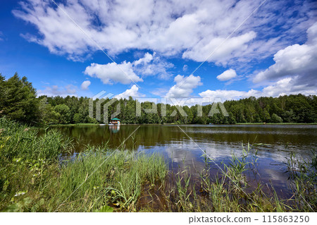 Beautiful summer river at sunny day with clouds reflection in the water Beautiful summer river at sunny day with clouds reflection in the water 115863250