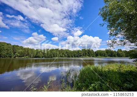 Beautiful summer river at sunny day with clouds reflection in the water Beautiful summer river at sunny day with clouds reflection in the water 115863253