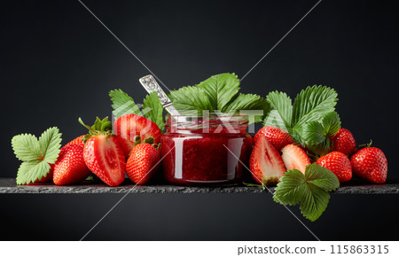 Strawberry jam and fresh berries on a black background. 115863315