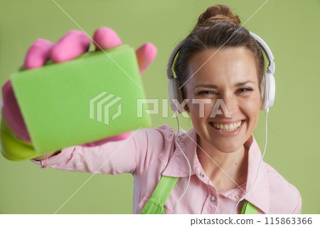 smiling modern woman isolated on green background 115863366