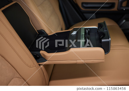 Luxury car back seat with open arm rest in sleek hardwood design Luxury car back seat with open arm rest in sleek hardwood design 115863456
