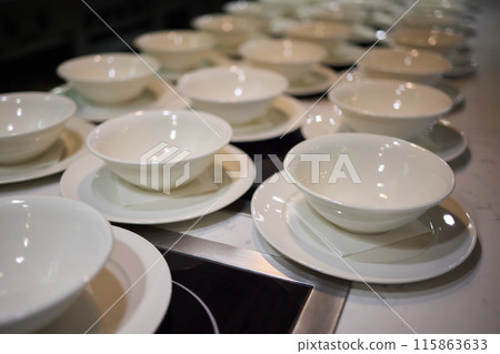 Neatly stacked white coffee cups for elegant events or catering, making a stylish presentation 115863633
