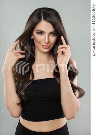 Cute young adult model woman with long healthy hairstyle, fresh shiny clear skin and makeup posing  115863670