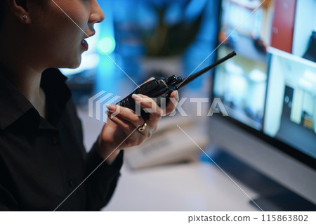 Security Worker Talking By Radio With Colleague 115863802