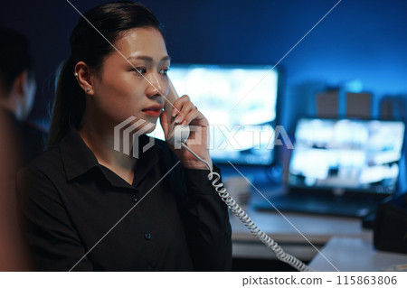 Woman Talking On The Phone In Security Post 115863806