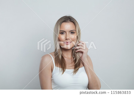 Cute model woman with long hairstyle and healthy clean fresh skin looking at camera Cute model woman with long hairstyle and healthy clean fresh skin looking at camera 115863833