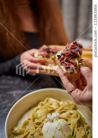 Enjoy a luxurious dining experience with pasta dishes and appetizers for a gourmet meal 115863868