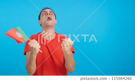 Man cheering for Portugal screaming and waving a national flag Man cheering for Portugal screaming and waving a national flag 115864266
