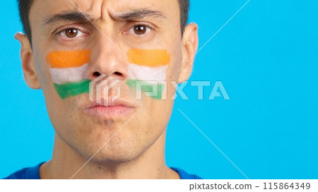 Serious man with a indian flag painted on the face 115864349