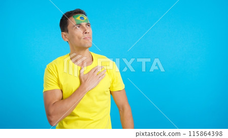 Brazilian patriot listening to the national anthem with solemnity 115864398