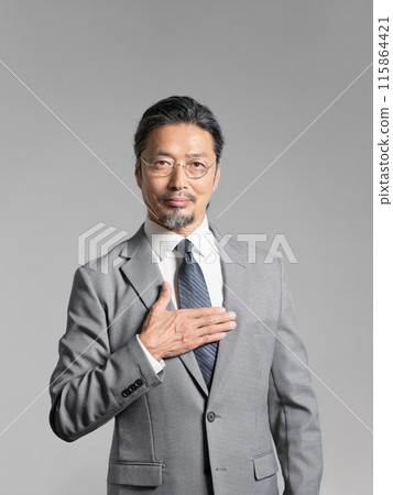 Portrait of a senior businessman with his hand on his chest Portrait of a senior businessman with his hand on his chest 115864421