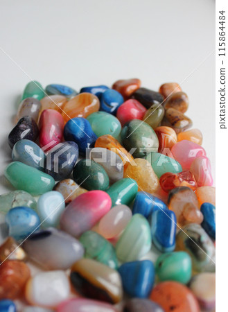 Heap Of Scattered Colorful Gemstones Receding Into The Distance On White Background Vertical Image 115864484