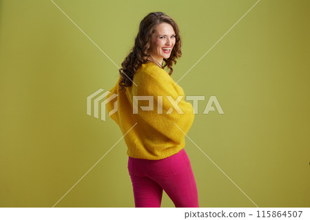 smiling trendy woman against green background smiling trendy woman against green background 115864507