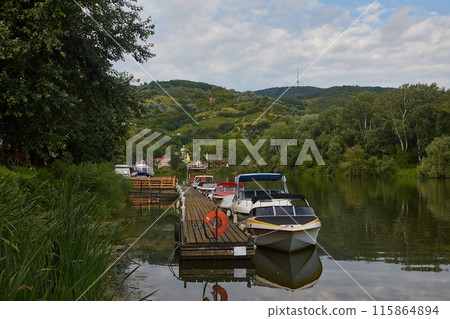 Lakeside pier with boats 115864894