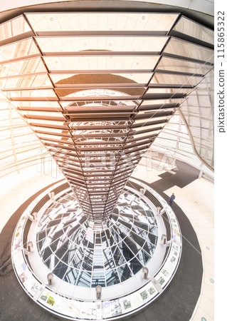 The intricate metal spiral ramp leading upwards inside the modern glass dome of the Reichstag Building, under a soft light. Berlin, Germany The intricate metal spiral ramp leading upwards inside the modern glass dome of the Reichstag Building, under a soft light. Berlin, Germany 115865322