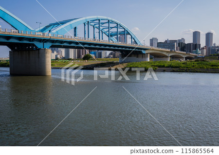 Riverside view of Japan's Tama River in Tokyo, overlooking the buildings of Musashi-Kosugi Riverside view of Japan's Tama River in Tokyo, overlooking the buildings of Musashi-Kosugi 115865564