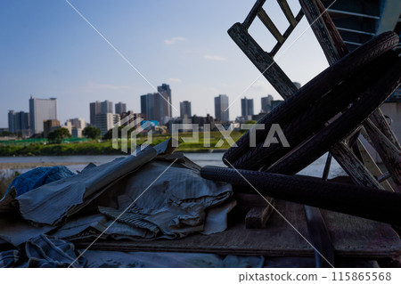 A homeless man's perspective along the Tama River in Tokyo, Japan, overlooking the buildings of Musashi-Kosugi 115865568