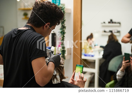 Stylist coloring hair in beauty salon with customers. Stylist coloring hair in beauty salon with customers. 115866719